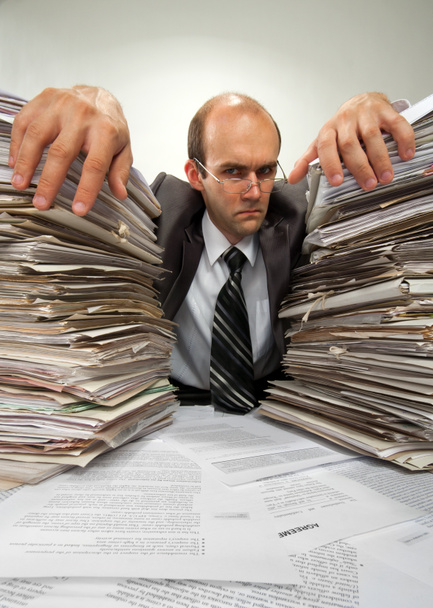 Businessman with big piles of paperwork - Photo, Image