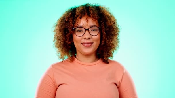 Face, funny and black woman with laughter, joke and happiness against a blue studio background. Portrait, African American female and girl with smile, cheerful and comic with joy, humor and happy. - Footage, Video