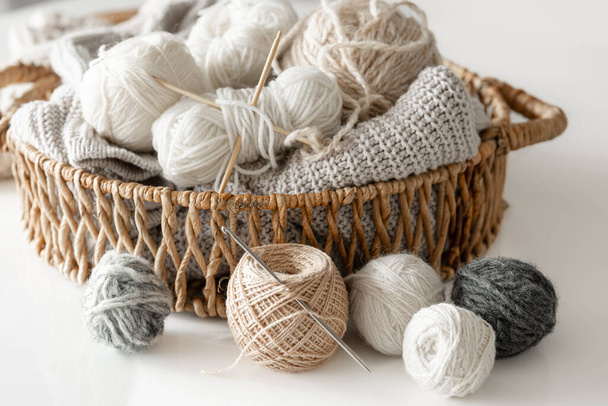 Basket with yarn close-up, pastel color threads for knitting on a blurred white background. - Foto, immagini