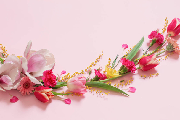 beautiful spring flowers on pink background - 写真・画像