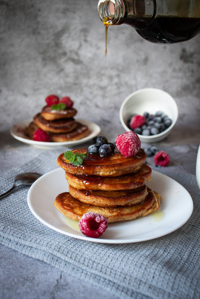 Pancakes with berries. breakfast. On a concrete background - Фото, изображение