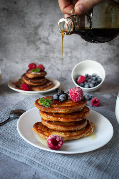 Pancakes with berries. breakfast. On a concrete background - Photo, Image