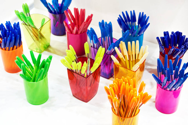Modern colored plastic ballpoint pens on store display - Fotó, kép