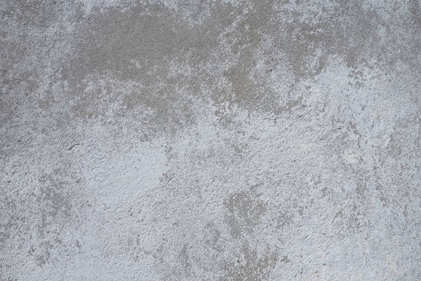 Plastered wall texture. Whitewash surface. Abstract background. Retro wall built structure texture. Cracks and bumps on the concrete wall. Uneven coloring with water-based paint. Old tattered plaster. - Photo, image