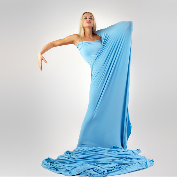 The girl in a long blue dress. - Valokuva, kuva
