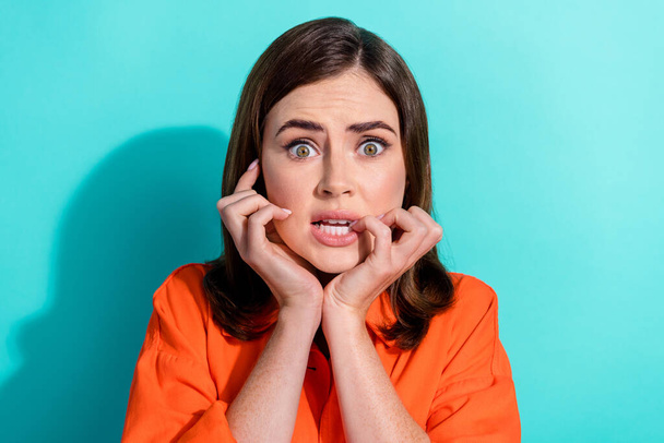 Photo of anxious embarrassed lady wear stylish clothes bite fingernails watching horror film isolated on cyan color background. - Фото, изображение