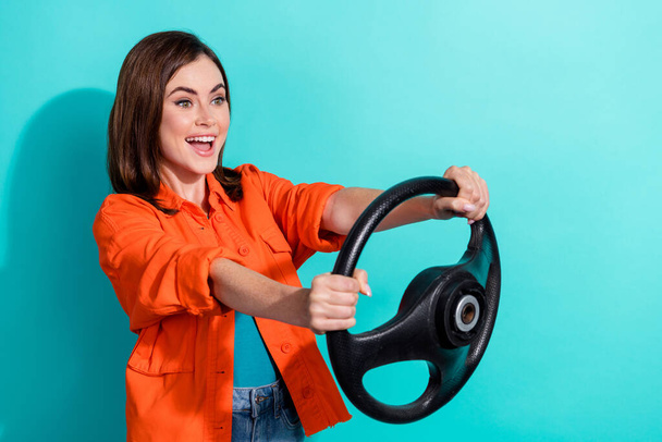 Photo of positive lovely lady wear stylish clothes look empty space trip new own car fast vehicle isolated on cyan color background. - Фото, зображення