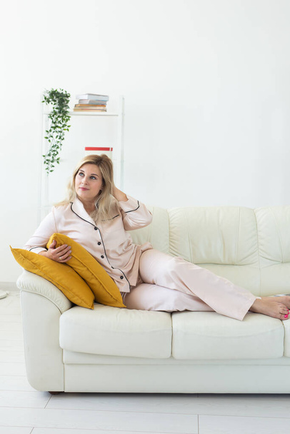 Glamorous woman wears pajama with happy smile chilling in good morning. Positive female model homewear and free time holidays at home - 写真・画像