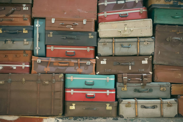 Stack of colorful vintage suitcases. Retro decorative suitcases, new vacation plans and journeys. old style suitcases stacked on top of each other - Photo, image