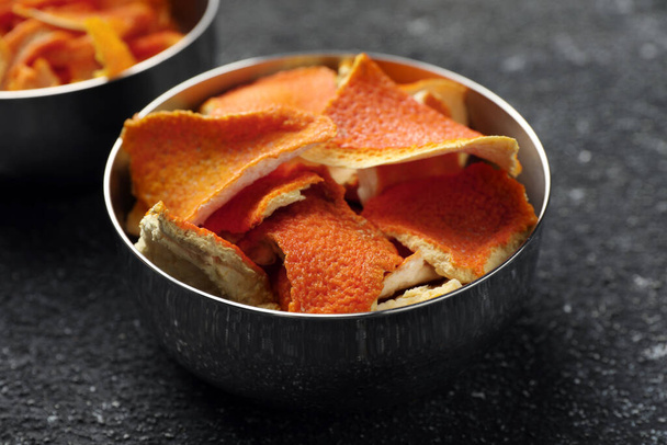 Bowls with dry orange peels on gray textured table, closeup - Foto, Imagem