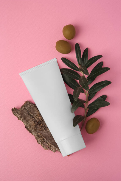 Natural cosmetic. Flat lay composition with olive cream on pink background - Photo, Image