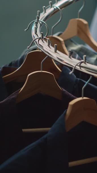 Vertikales Video: Leerer Kleidermarkt gefüllt mit Regalen und Kleiderbügeln, moderne Kleidungsstücke hängen im Einkaufszentrum. Modeboutique mit Hemden auf Rabatt, kommerzielle Aktivitäten für Kleinunternehmen. - Filmmaterial, Video