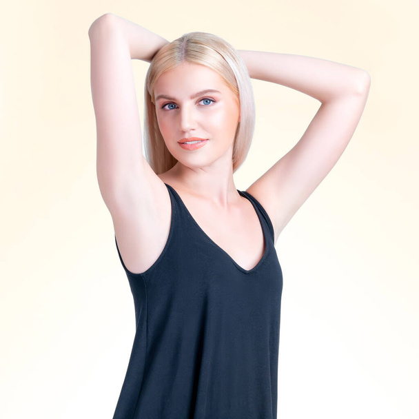 Personable woman lifting her armpit showing hairless hygiene underarm as beauty posing for cleanliness and perfect smooth skincare treatment in isolated background. Hair removal and epilation concept. - Fotografie, Obrázek