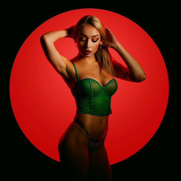 Fashion art photo of elegant model in seductive green lingerie with light neon colored club spotlights - Foto, Imagem