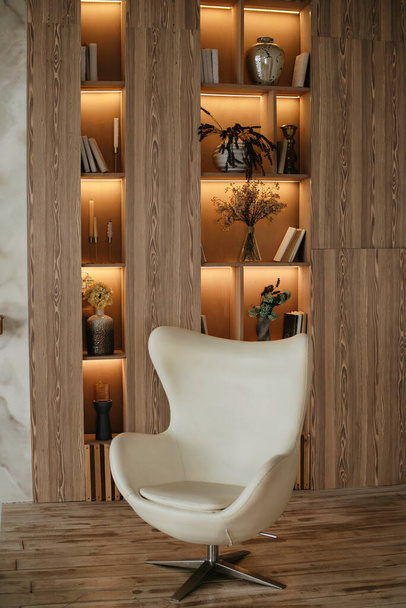 A white stylish chair on the background of a cabinet - Photo, Image