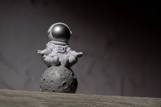 Plastic toy figure astronaut on moon concrete background Copy space. Concept of out of earth travel, private spaceman commercial flights. Space missions and Sustainability - Fotografie, Obrázek
