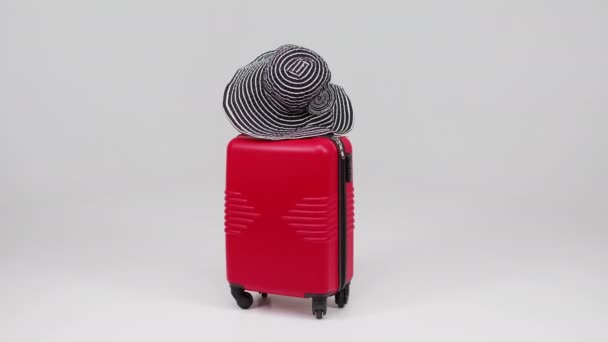 Straw hat on a trendy suitcase on a light background. Summer tourism concept. Traveling lifestyle. Sea sunset. Buying tickets online - Footage, Video