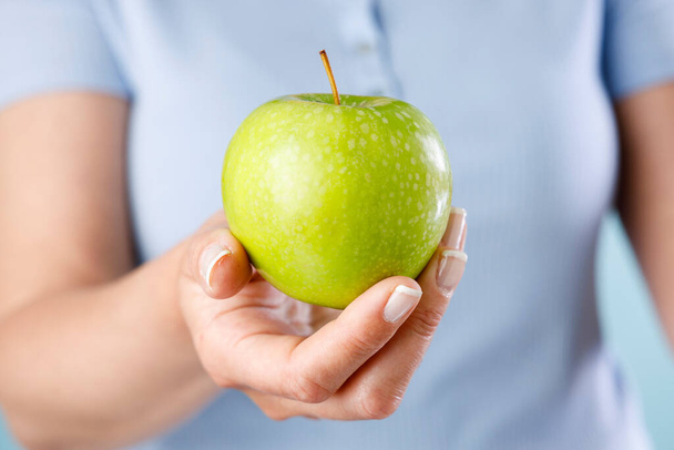 Woman holding green apple - Photo, Image