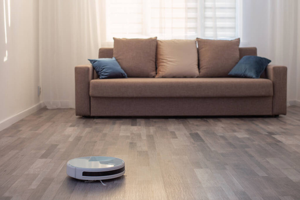 robot vacuum cleaner on the floor in  living room - Photo, Image