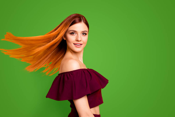 Red straight-haired attractive cute nice cheerful young girl, half turned, wind blowing hair. Isolated over bright vivid yellow background. - Fotografie, Obrázek