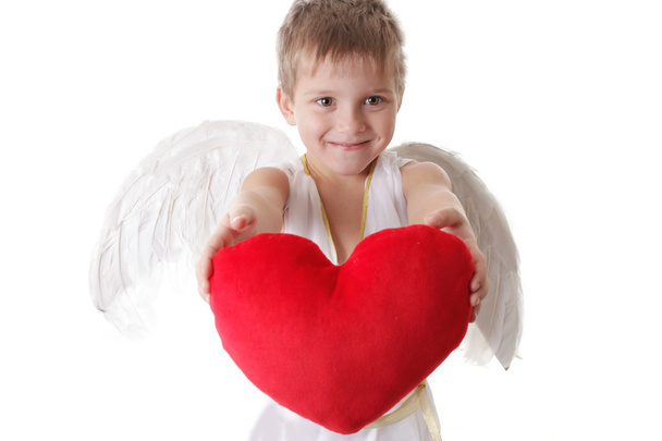 Cupid jongen met vleugels en rode pluche hart - Foto, afbeelding