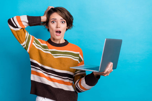 Photo of sad upset lady wear striped sweater reading bad news modern device empty space isolated blue color background. - Foto, Imagem