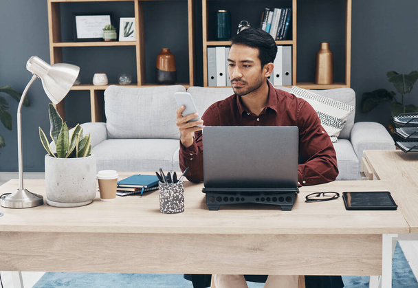 Asian man, phone and texting in office for email communication, corporate schedule and laptop. Entrepreneur, businessman or focus with smartphone for networking, tech and web chat app with digital ux. - Foto, Imagen