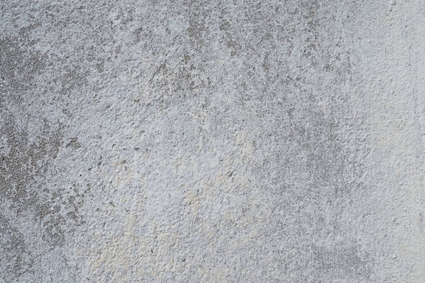 Plastered wall texture. Whitewash surface. Abstract background. Retro wall built structure texture. Cracks and bumps on the concrete wall. Uneven coloring with water-based paint. Old tattered plaster. - Foto, imagen