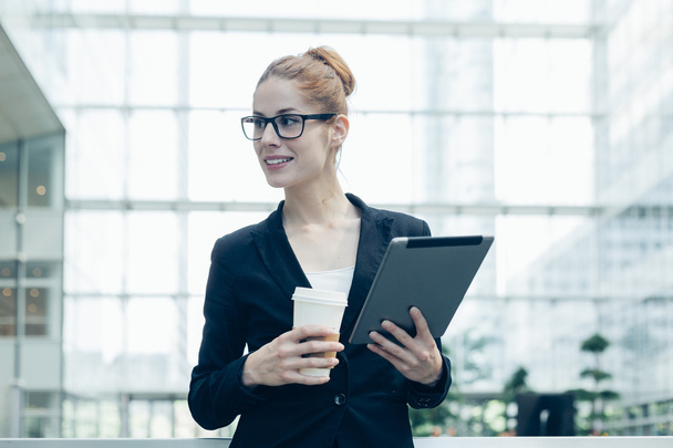 Businesswoman using a digital tablet - Foto, immagini