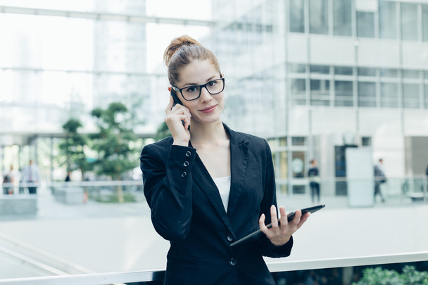 Businesswoman using a mobile phone - Photo, image