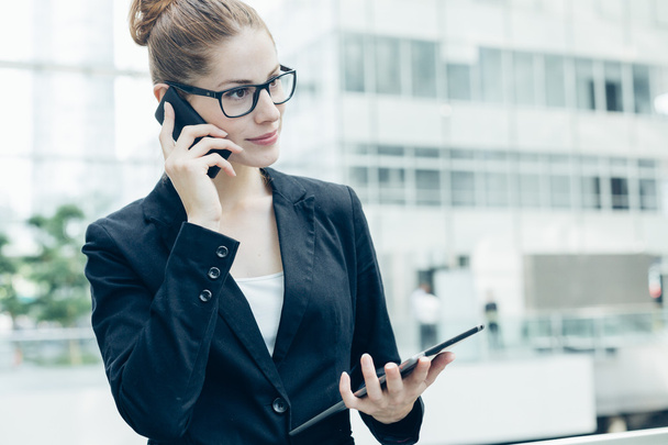 Businesswoman using a mobile phone - Photo, image