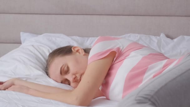 Eine Frau wacht nachts mit Schlaflosigkeit auf, der ständige Lärm um sie herum nervt sie, sie ist depressiv. Schlafstörungen. 4k-Video - Filmmaterial, Video