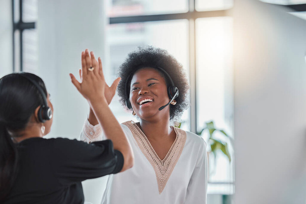 Employees, customer service and woman in office, high five and celebration for target, success and motivation. Female consultants, agents and friends with gesture for achievement, goal and support. - Foto, immagini
