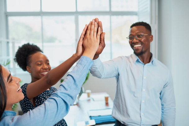 Three colleagues give high five in office, celebrate success, happy teamwork. High quality photo - Fotoğraf, Görsel