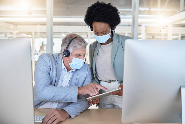 Covid, call center and coaching employees with mask at computer, help for senior man and black woman with tablet. Compliance, consulting and sharing opinion for medical advisory agency with diversity. - Foto, Imagen