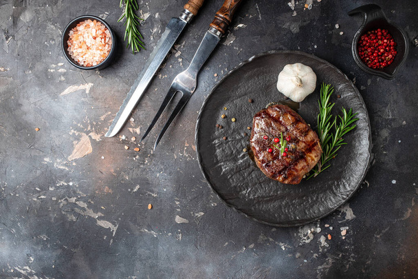 Grilled beef tenderloin steak. Restaurant menu, dieting, cookbook recipe top view. - Foto, Bild