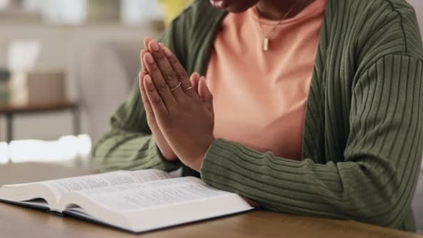 Black woman, hands and praying, worship with Bible and Christian, faith and spiritual, gratitude and hope in religion. Religious scripture, trust and female in prayer with respect, holy book and God. - Footage, Video