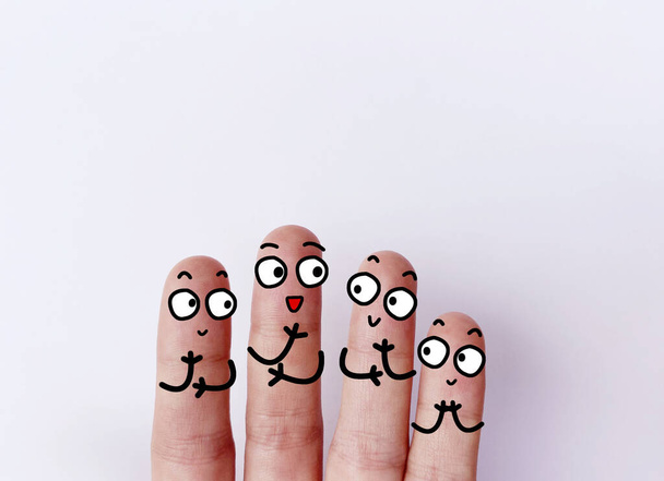 Four fingers are decorated as four person. They are happy. - Photo, Image