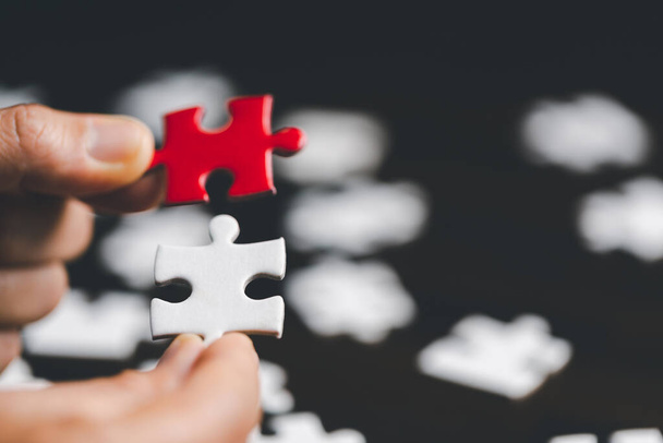 Business woman person hand holding puzzle piece idea for strategy and solution. Closeup part of two jigsaw connect together. Concept of join cooperation success teamwork-problem corporate team - 写真・画像