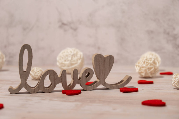 Wooden word love with heart romance. Minimal concept of greeting card for Valentines Day, Mothers Day, Womens Day Festive holiday card concept. Wedding anniversary decor. - Photo, image