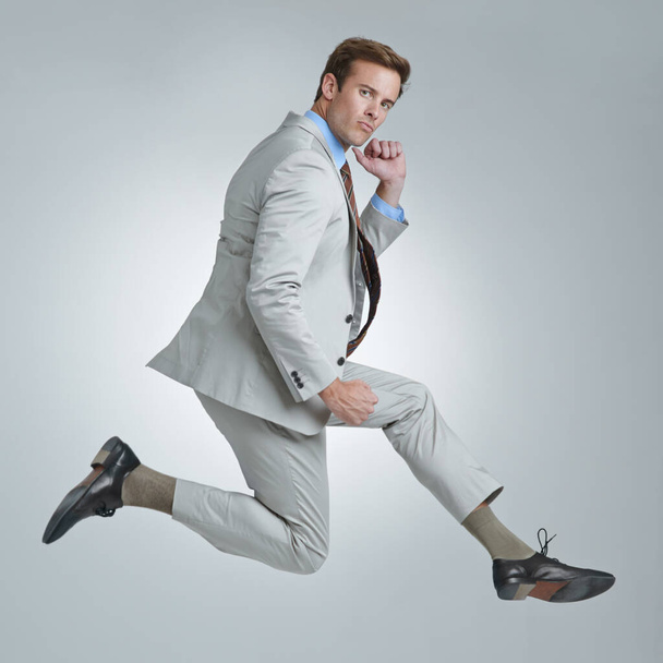 Business ego. A young businessman wildly celebrating his success - Foto, Imagen