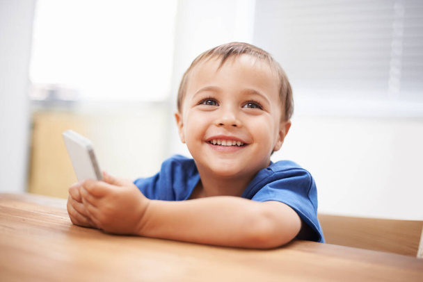 Découvrir le monde de la technologie. un petit garçon mignon jouant avec un téléphone portable - Photo, image