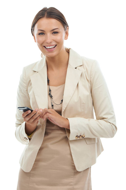 My phone is like a mobile office. Studio portrait of a young businesswoman holding a cellphone isolated on white - Foto, afbeelding