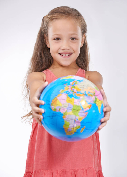 Save the planet for the next generation. Portrait of a sweet little girl holding a globe - Foto, immagini