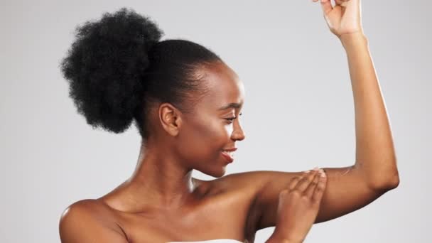 Wellness, body care and black woman in studio with health, beauty and cosmetic routine. Self care, glowing and African model touching skin after hair removal, epilation or shaving by gray background - Footage, Video