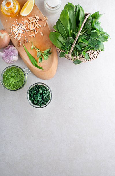 Spring healthy food. Nettle and ramson pesto for healthy meal on grey background - Valokuva, kuva