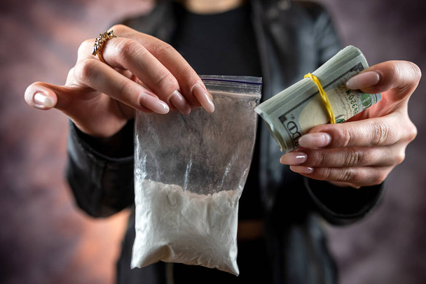 woman wear black cloth hold dollar and dose of cocaine or heroine. Drug addiction concept. Overdose - Zdjęcie, obraz