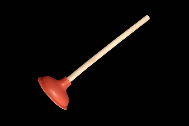 Red toilet plunger, Isolate on black background. Plumbers drain cleaner tool. Equipment for clearing blockages - Photo, Image
