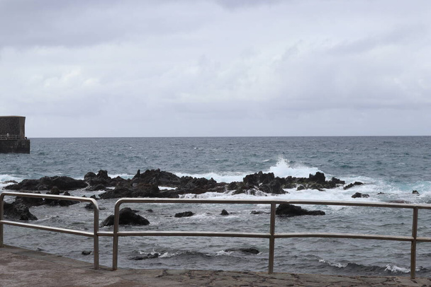 The force of the sea in a cloudy day in Puerto de la Cruz in Tenerife, Canary Islands, Spain, Europe - Photo, Image