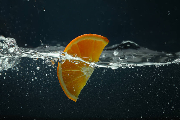 Tranche d'orange dans l'eau, concept de fraîcheur - Photo, image